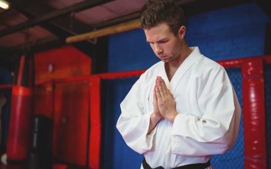 Karate player in prayer pose Karate player in prayer pose<br />